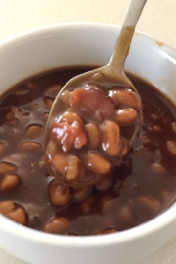 Easy BBQ Baked Beans served in a white bowl with a spoon