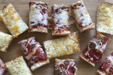 Fast and Easy French Bread Pizza cut into pieces to eat
