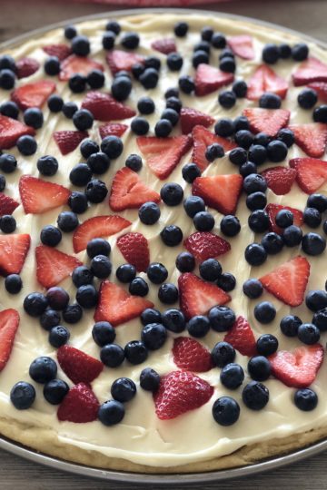 4th of July Sugar Cookie Fruit Pizza with blueberries and strawberries on top.