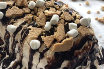 S’mores Ice Cream Cake with chocolate, Graham crackers and marshmallows on top.