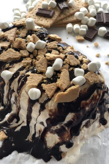 S’mores Ice Cream Cake with chocolate, Graham crackers and marshmallows on top.