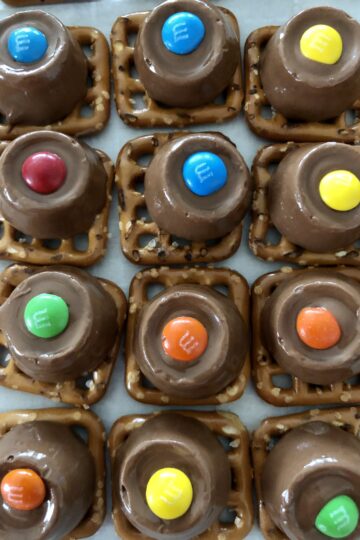 Rolo Pretzel Bites lined up on a pan